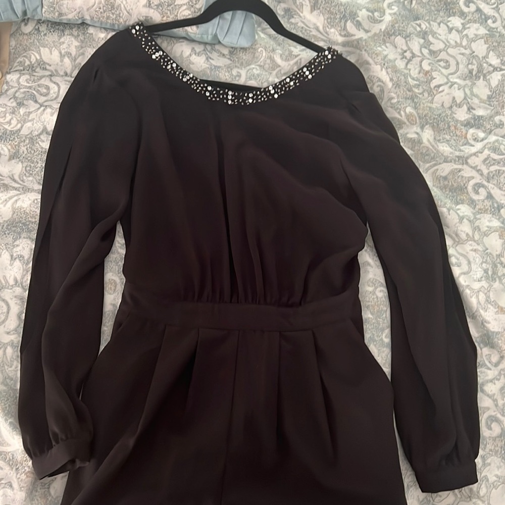 Black long sleeve romper shorts with crystals on neck line. US size: 8